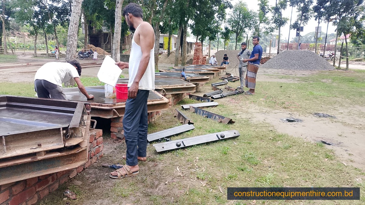 Workers applying release oil