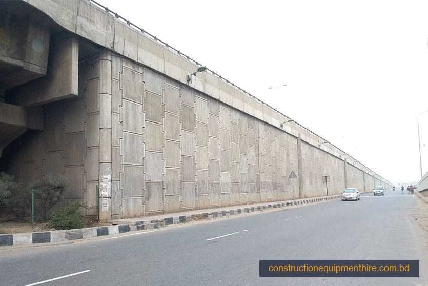 Completed retaining wall — urban expressway overpass protection